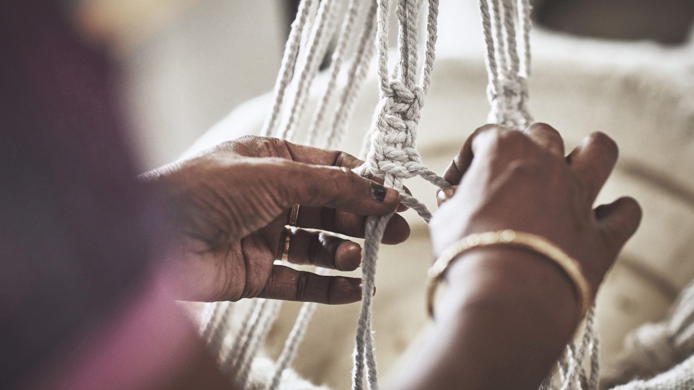 Woman sits and works with locally produced products.
