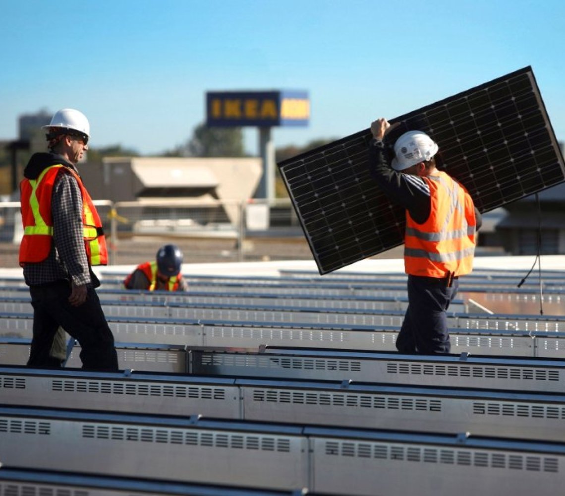 Solar panels are being mounted on an IKEA stores rooftop.