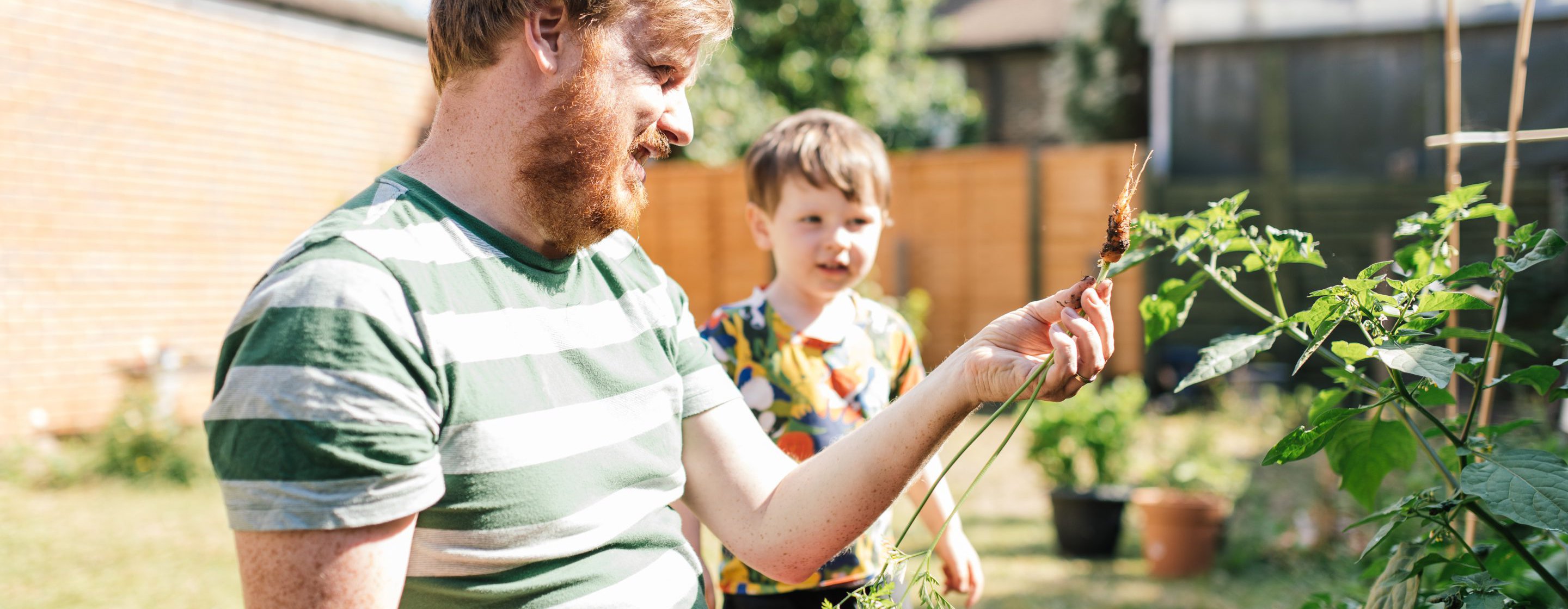 Man and child in a garden with plants