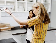 Woman getting help from IKEA employee in the kitchen department.